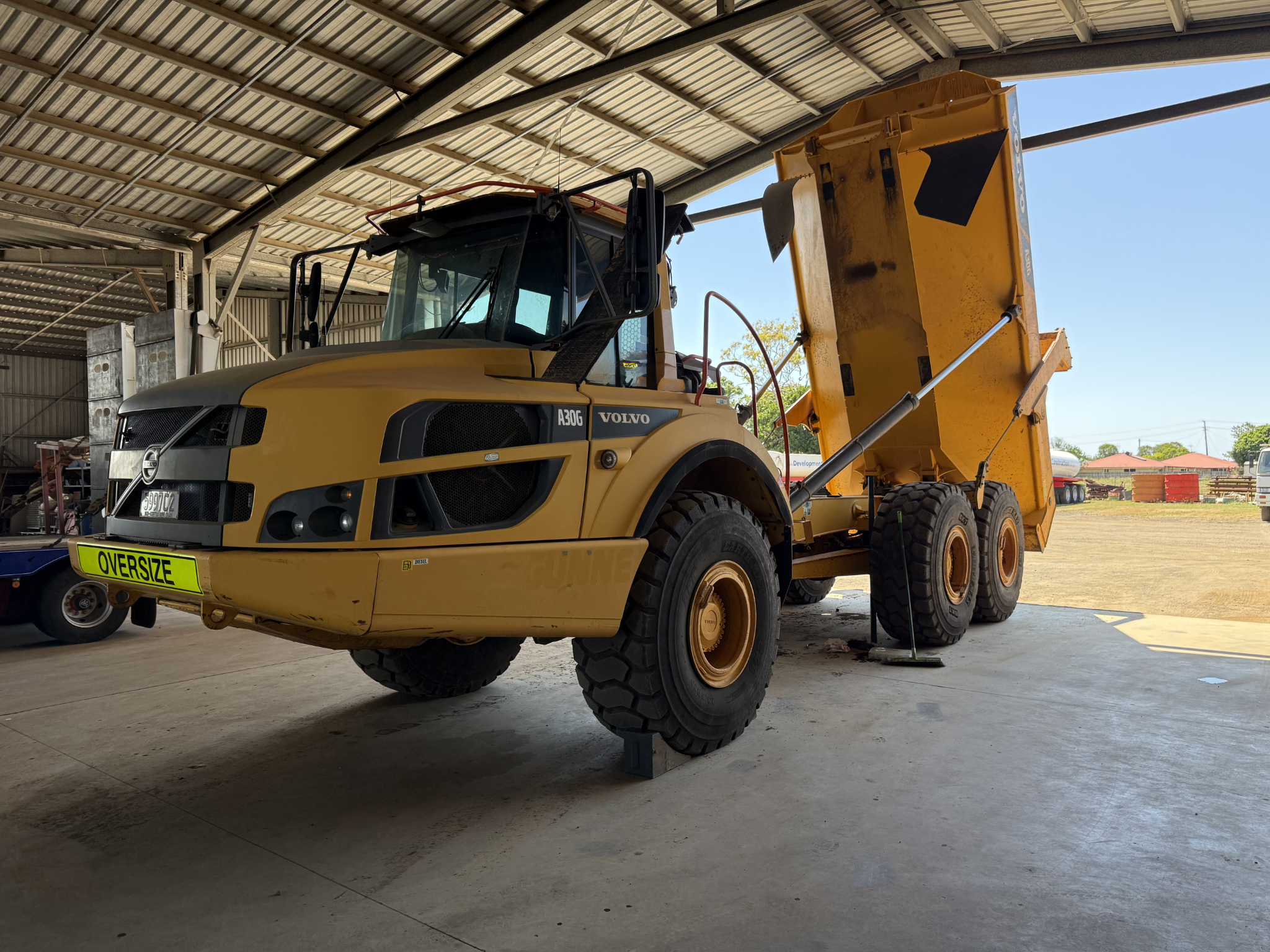 Articulated dump truck inside workshop for diesel mechanical servicing and heavy equipment maintenance by NLJ Contracts